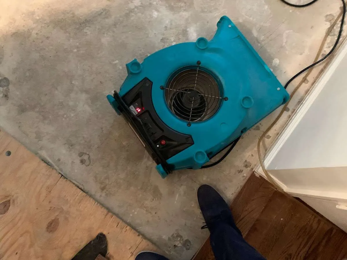 Air mover drying subfloor during Commercial Water Damage Restoration in Van Buren
